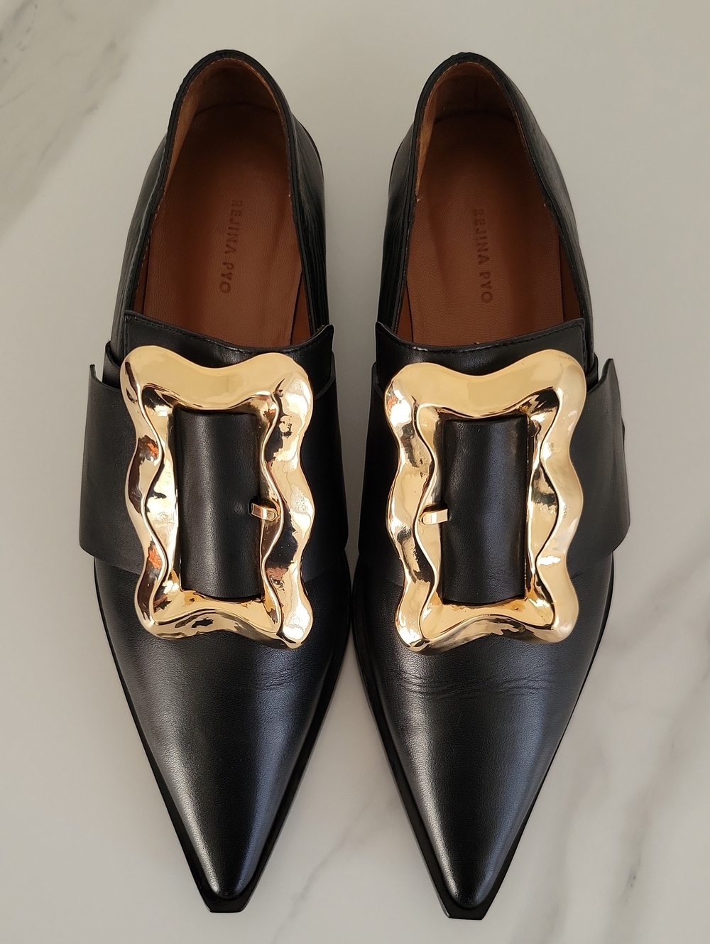 Rejina Pyo Black Leather Pointed Loafers with Gold Sculpted Buckle